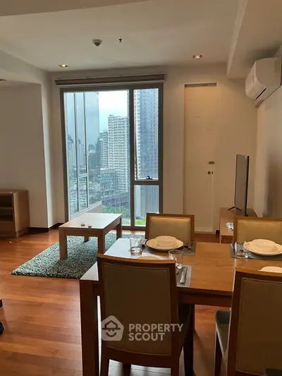 Modern living room with dining area and city view in high-rise apartment