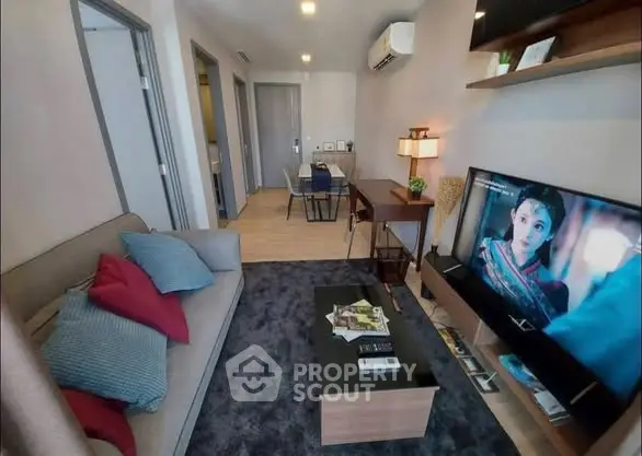 Modern living room with cozy sofa, TV, and stylish decor in a contemporary apartment.