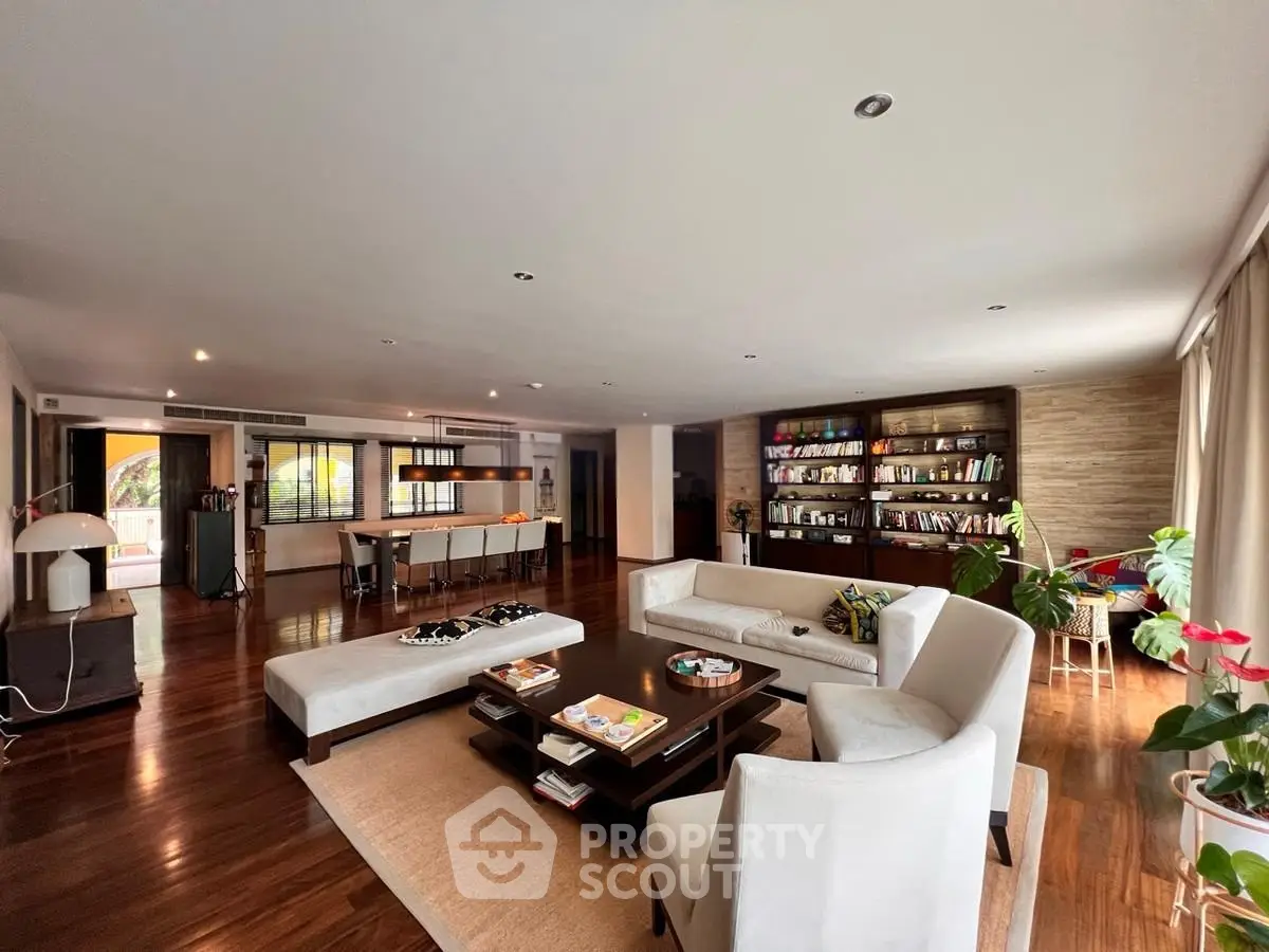 Spacious open-plan living room with elegant decor and hardwood floors