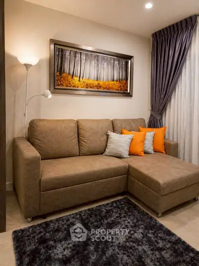 Cozy living room with stylish brown sofa, modern decor, and elegant lighting.