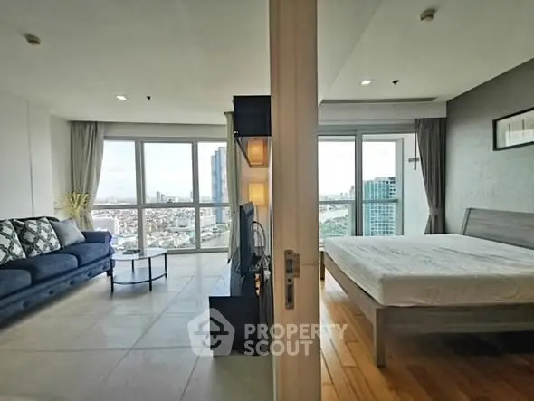 Spacious modern apartment with stunning city views, featuring a cozy living room and elegant bedroom.