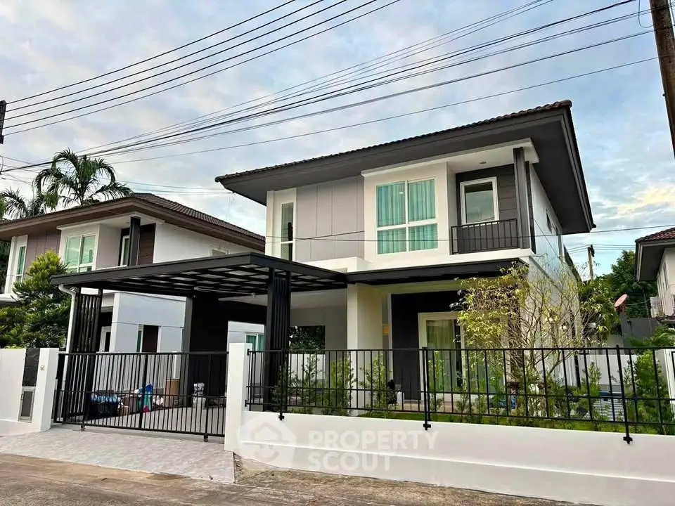 Modern two-story house with sleek design and spacious driveway in a serene neighborhood.