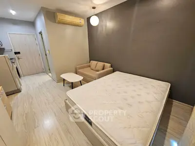 Modern studio apartment with cozy living area and comfortable bed