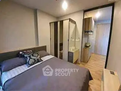 Cozy bedroom with modern decor and ample storage space in a stylish apartment.