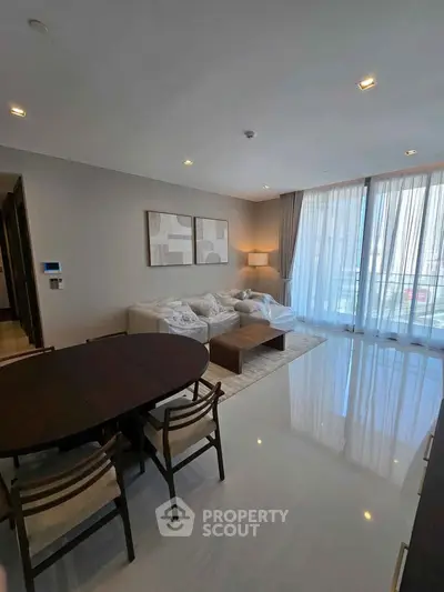 Spacious modern living room with elegant decor and large windows for natural light.