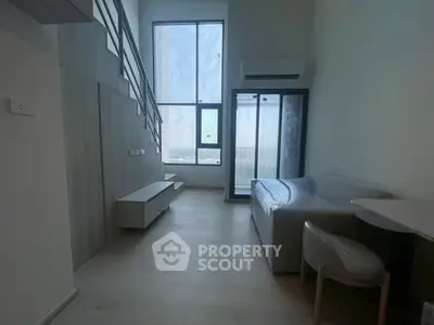 Modern living room with high ceiling and large windows in a stylish apartment