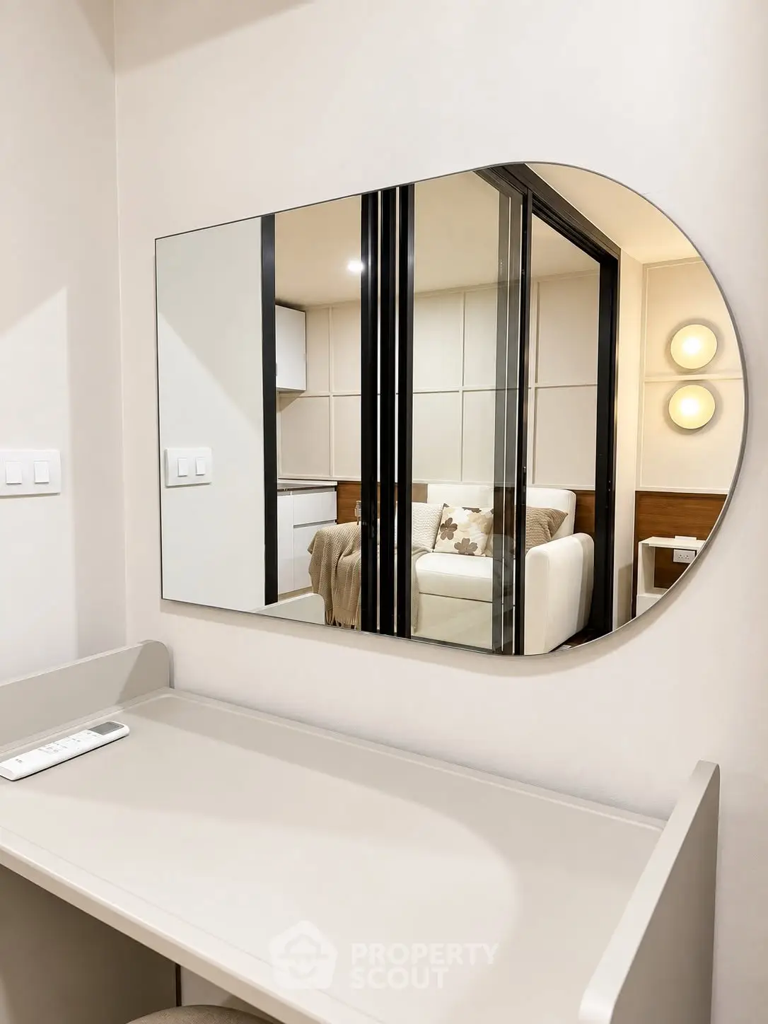 Modern interior with stylish mirror reflecting cozy living area and contemporary decor.