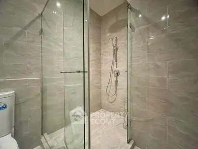 Modern bathroom with glass shower enclosure and sleek tile design