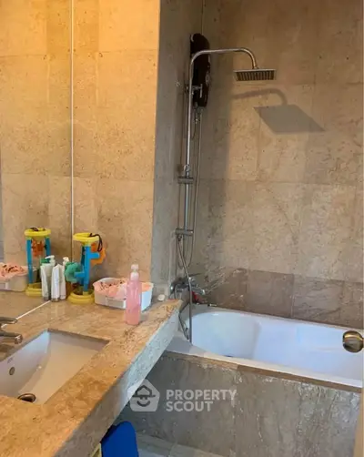 Modern bathroom with elegant stone tiles and bathtub