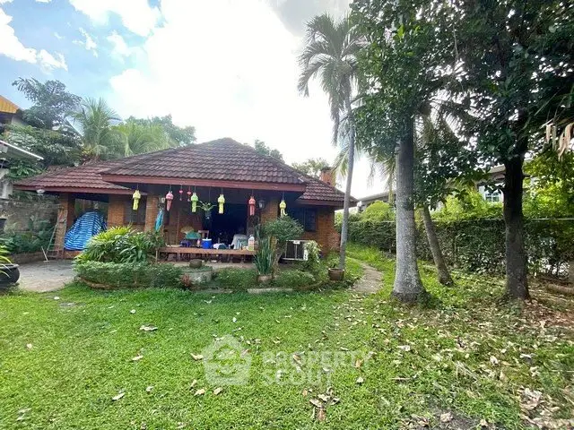 Charming tropical bungalow with lush garden and spacious outdoor area.
