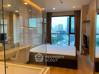 Luxurious bedroom with city view and modern furnishings in high-rise apartment.