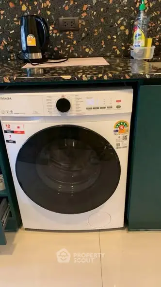 Modern kitchen with energy-efficient washing machine and stylish countertop