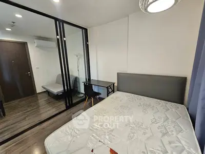 Modern bedroom with glass partition and study area in stylish apartment