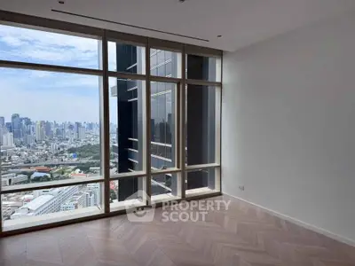 Stunning high-rise apartment with floor-to-ceiling windows offering breathtaking city views.