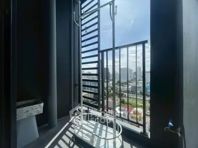 Modern balcony with city view and drying rack in urban apartment