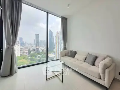 Modern living room with stunning city view through floor-to-ceiling windows.