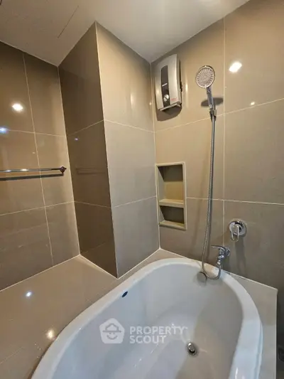 Modern bathroom with sleek bathtub and shower in contemporary design.