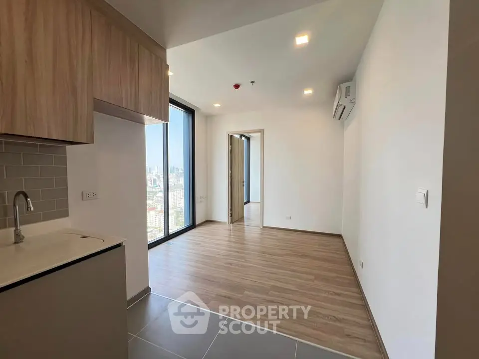 Modern apartment interior with wooden flooring and city view