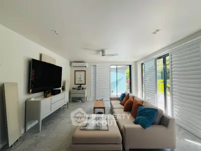 Spacious modern living room with large windows and stylish decor