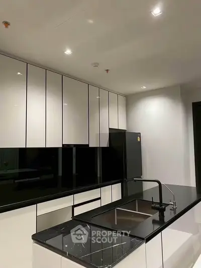 Modern kitchen with sleek black and white cabinetry and island