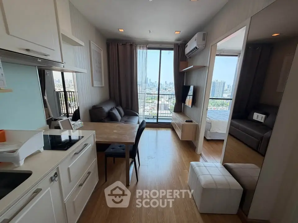 Modern apartment with open kitchen and stunning city view from the living room balcony.