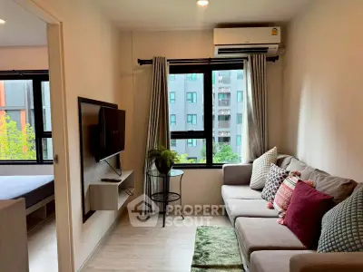 Modern living room with cozy sofa and wall-mounted TV, featuring large window with city view.