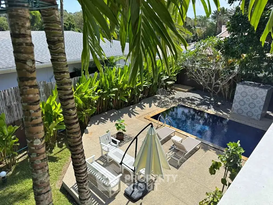 Stunning backyard oasis with pool and lush greenery, perfect for relaxation and outdoor entertainment.