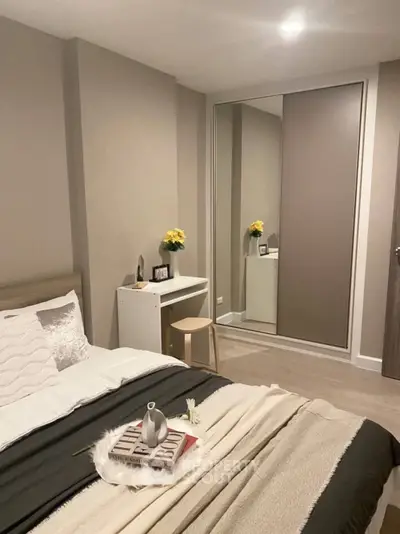 Cozy modern bedroom with stylish decor and mirrored wardrobe