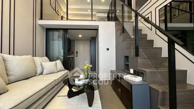 Modern duplex living room with stylish staircase and cozy seating area