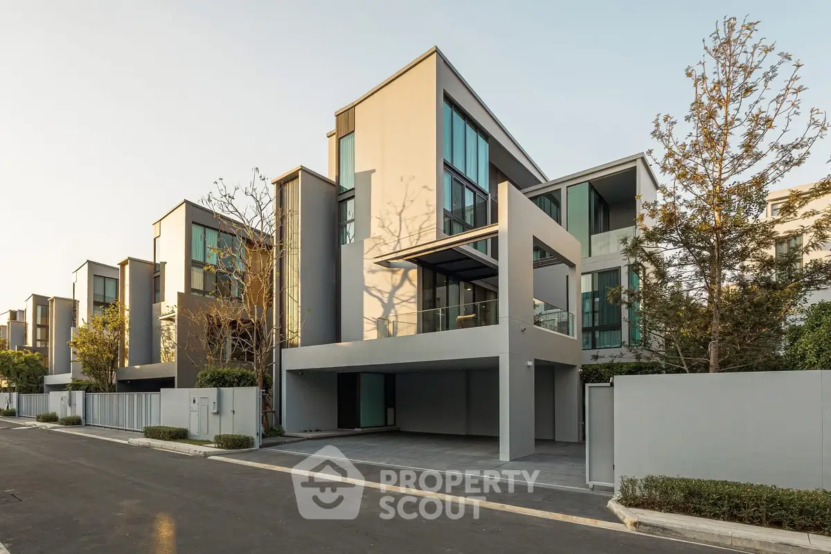 Modern luxury townhouse with sleek design and large windows in a serene neighborhood.