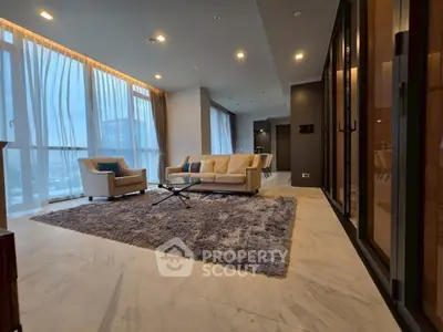 Luxurious modern living room with plush seating and panoramic city views.