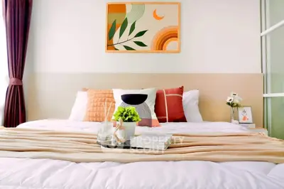 Cozy bedroom with modern decor and stylish artwork above bed