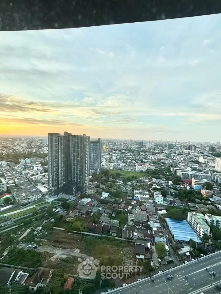 Stunning cityscape view from high-rise building at sunset, showcasing urban living.