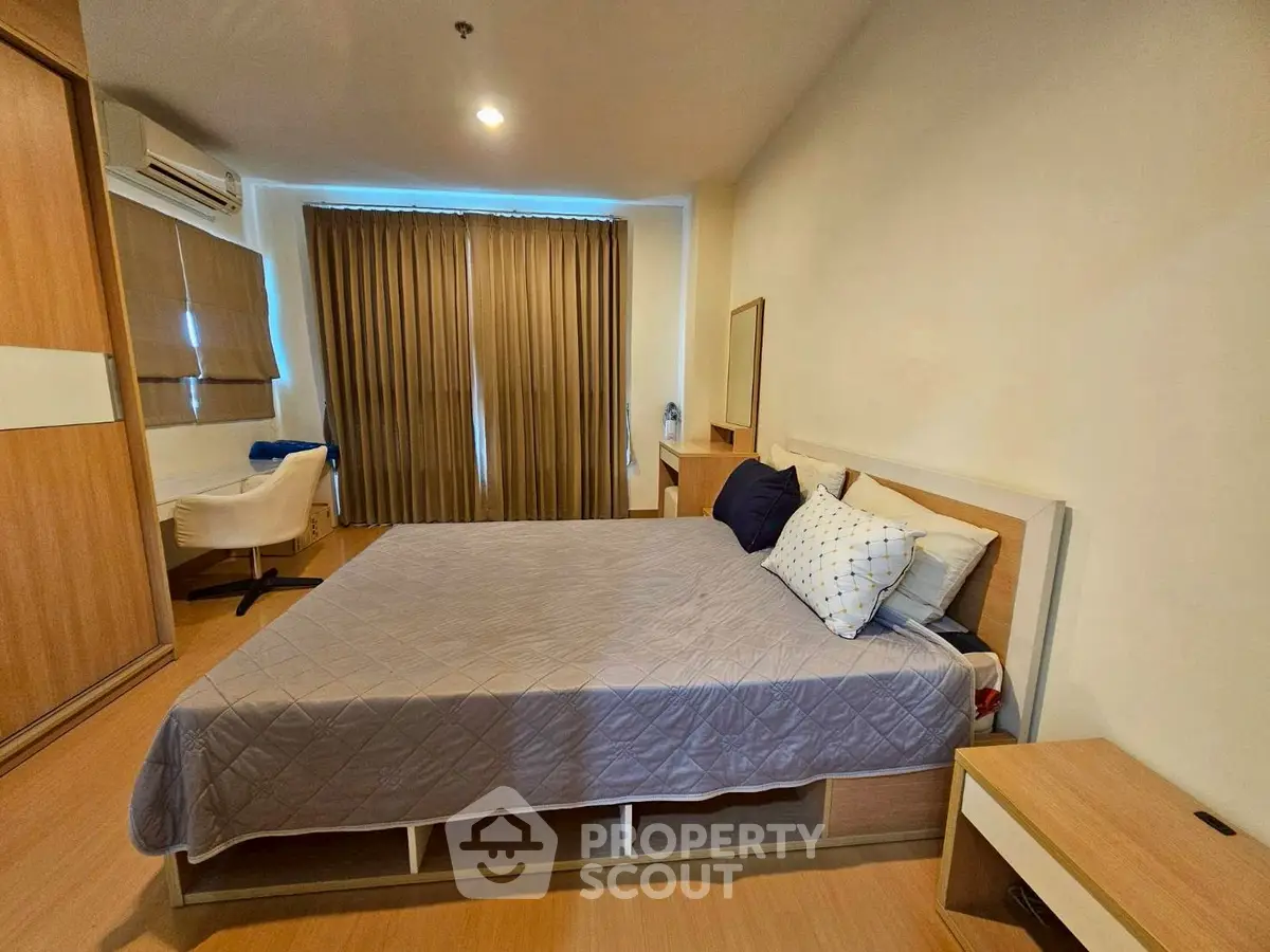 Spacious bedroom with modern furnishings and ample natural light