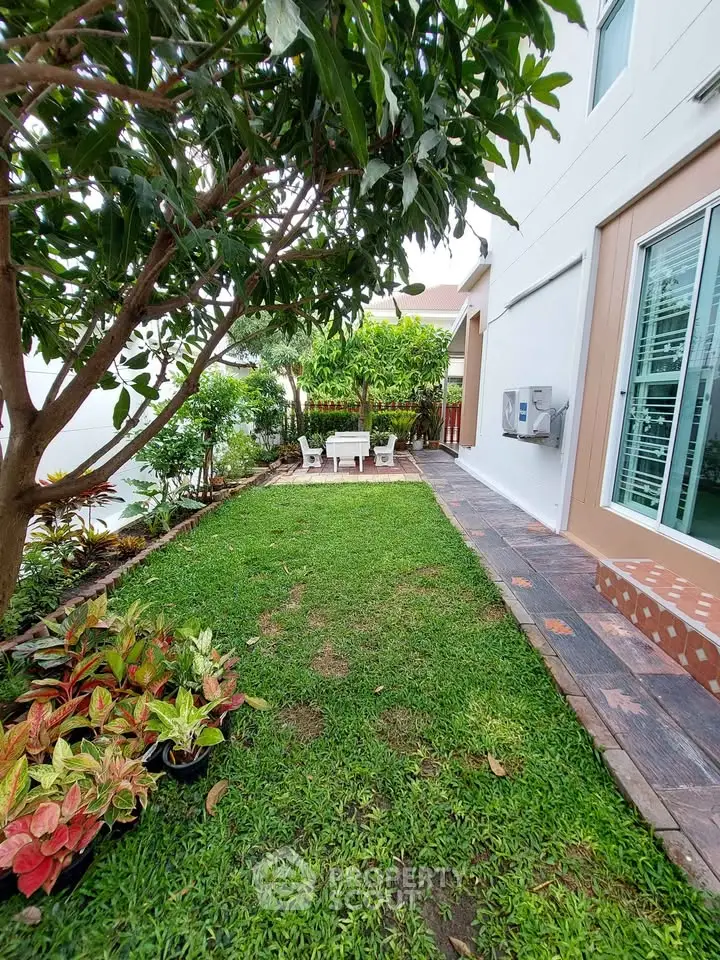 Charming garden area with lush greenery and cozy outdoor seating