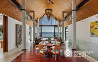 Luxurious dining area with stunning lake view and high wooden ceiling