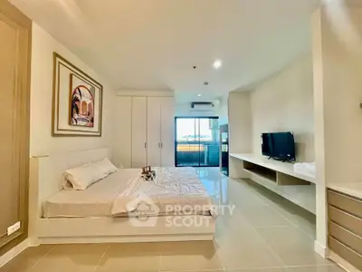 Spacious modern bedroom with sleek design and large windows offering natural light.