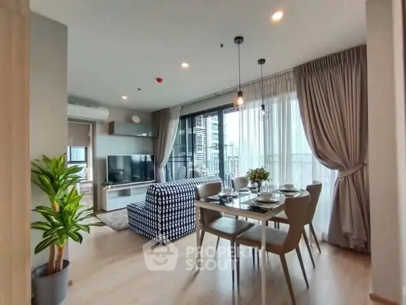 Modern living room with dining area and large windows in a stylish apartment.