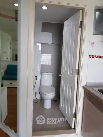 Compact bathroom with modern fixtures in a cozy apartment setting.