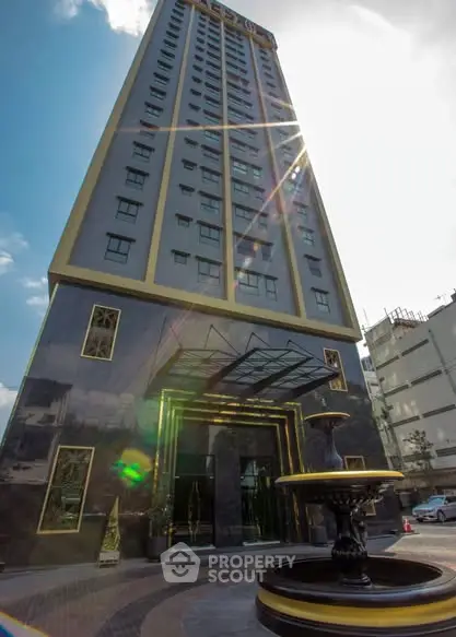 Stunning high-rise building with modern architecture and elegant entrance, perfect for luxury urban living.