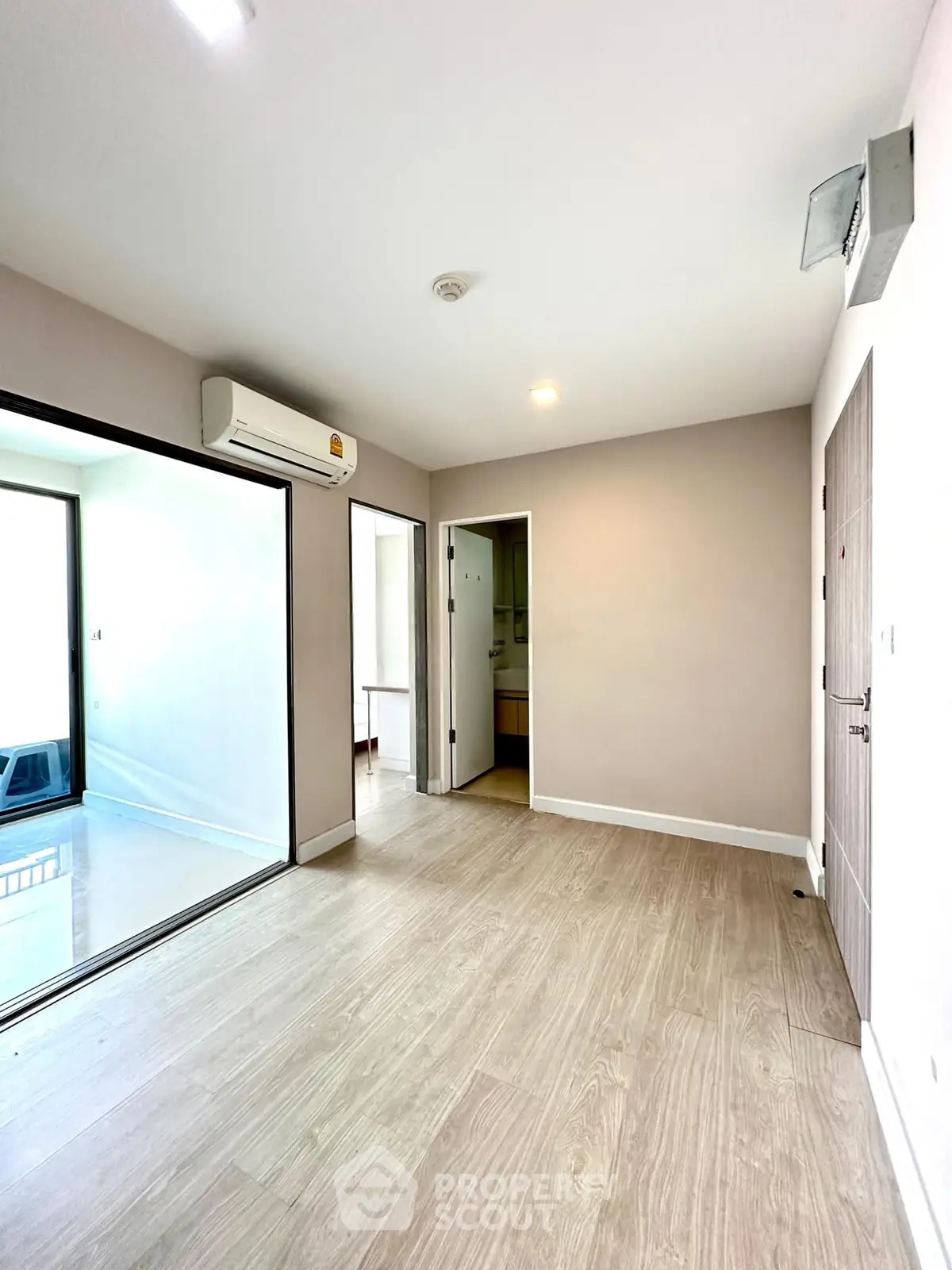 Spacious modern living room with wooden flooring and air conditioning