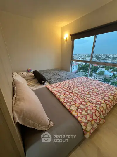 Cozy bedroom with large window offering stunning city views