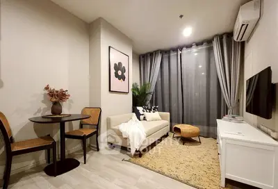 Chic modern living room with cozy sofa, stylish decor, and elegant lighting.