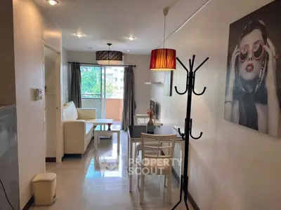 Modern living room with stylish decor and natural light, featuring a cozy seating area and dining space.