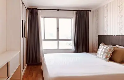 Cozy bedroom with elegant decor and large window for natural light