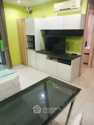 Modern living room with sleek furniture and vibrant green accent wall