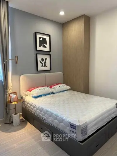 Modern bedroom with stylish decor and comfortable bed in a cozy apartment.