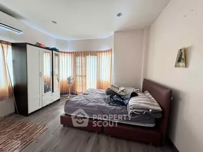 Spacious bedroom with natural light and modern furnishings