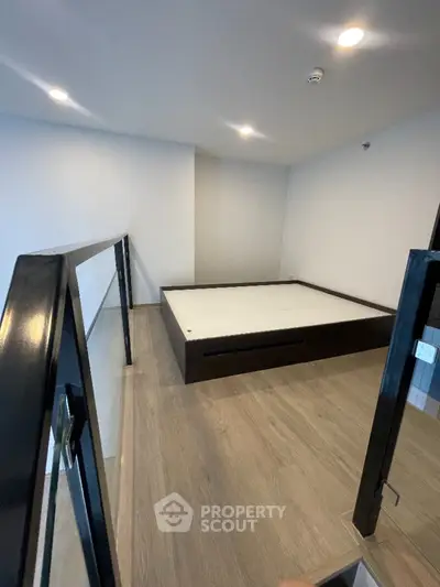 Modern minimalist bedroom with sleek design and wooden flooring