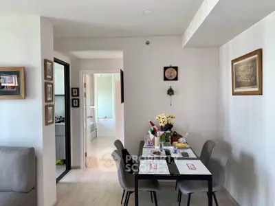 Charming dining area with modern decor and natural light in cozy apartment.